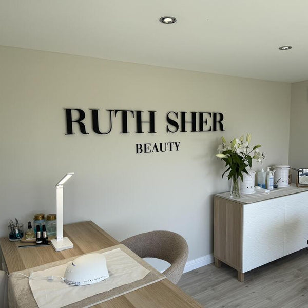 luxury black wall sign for beauty clinic reception UK